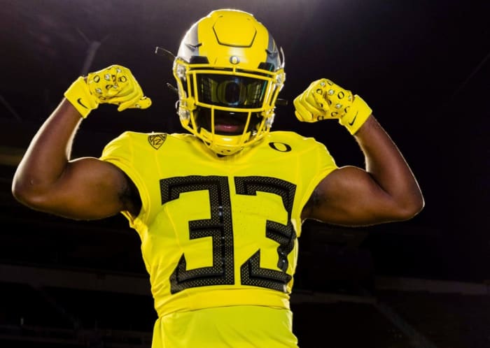 Cox poses in Oregon uniform during his recent trip to Eugene. Photos: Courtesy University of Oregon